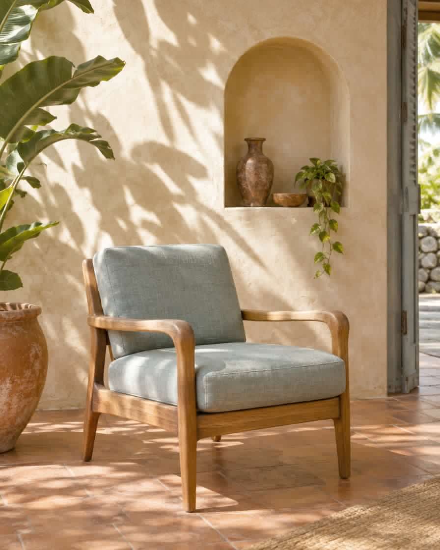 Solid wood armchair with a blue-grey seat in front of an arched niche